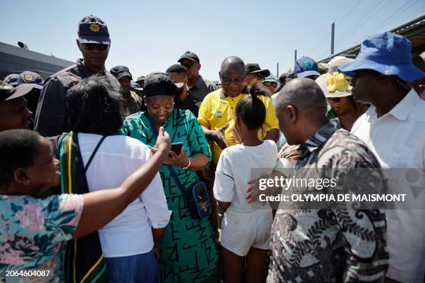 African National Congress president and South African President Cyril Ramaphosa greets a child during a walkabout and a meet and greet at the Chris...