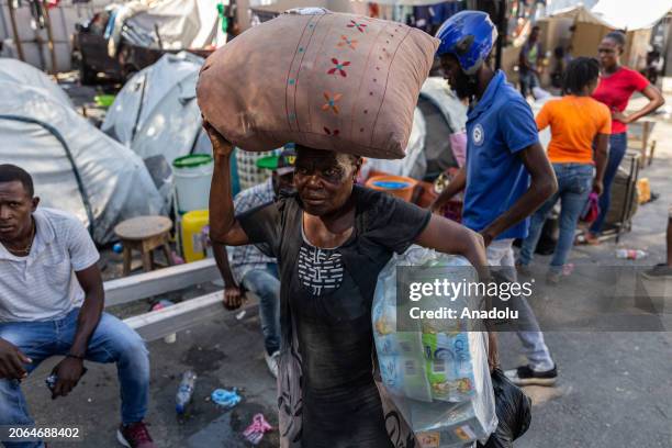 Woman passes to take refuge in the local welfare, as Haitians forced to flee their homes amid spiraling gang violence in port-au-prince, Haiti on...