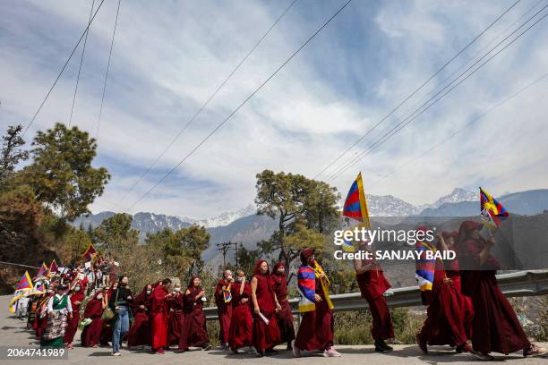 Tibetans living in exile in India attend a peace march during the 65th Tibetan National Uprising Day against the Chinese occupation of Tibet, in the...