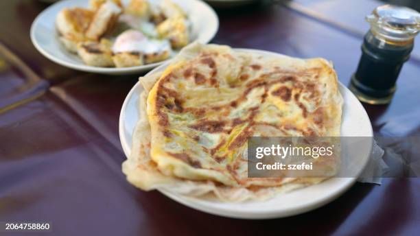 roti canai and charcoal grilled toast, popular indian street food in penang. - roti canai stock pictures, royalty-free photos & images