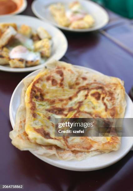 roti canai and charcoal grilled toast, popular indian street food in penang. - roti canai stock pictures, royalty-free photos & images