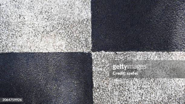 checked pattern pebbled concrete surface - pebbled road stock pictures, royalty-free photos & images