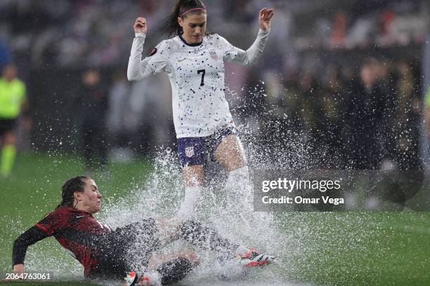 Alex Morgan of United States and Jessie Fleming of Canada battle for the ball during the Semifinals - 2024 Concacaf W Gold Cup match between Canada...
