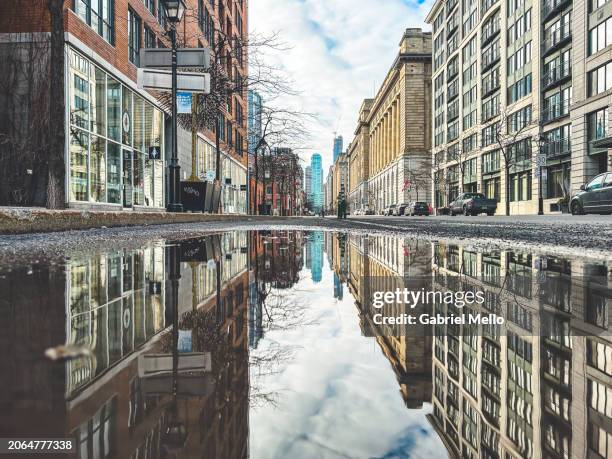 puddle reflection of city street in montreal - symmetry stock pictures, royalty-free photos & images