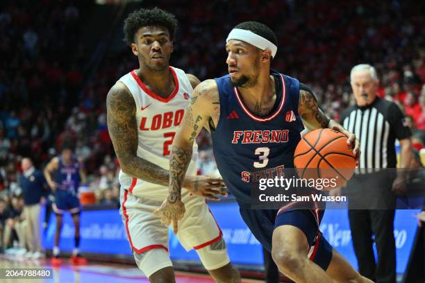 Isaiah Hill of the Fresno State Bulldogs drives against Donovan Dent of the New Mexico Lobos during the first half at The Pit on March 06, 2024 in...