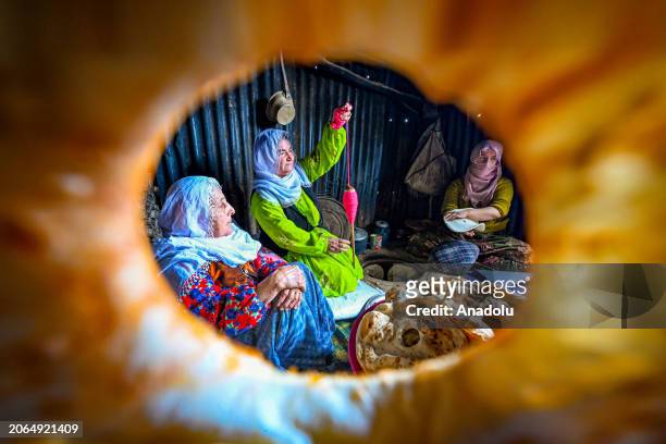Women of the region, which struggles with harsh weather conditions during winters, prepare lavash and walnut buns for iftar and sahur of Ramadan...