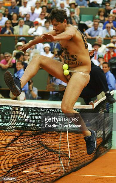 Male streaker jumps the net in the men's final match between Juan Carlos Ferrero of Spain and Martin Verkerk of the Netherlands during the 14th day...