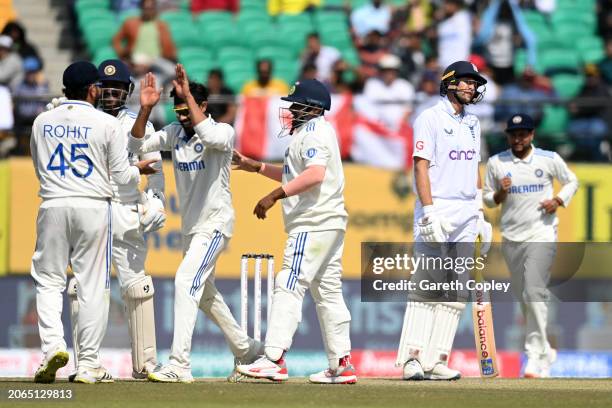 Joe Root of England reacts after being dismissed by Ravindra Jadeja of India during day one of the 5th Test Match between India and England at...