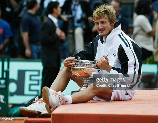 Juan Carlos Ferrero of Spain celebrates with the trophy after winning his mens final match against Martin Verkerk of the Netherlands during the 14th...