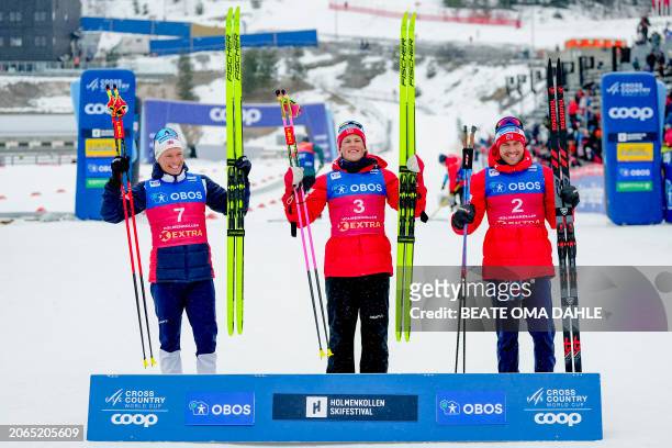 Norway's Johannes Hoesflot Klaebo celebrates winning with second placed Norway's Martin Loewstroem Nyenget and third placed Norway's Paal Golberg...