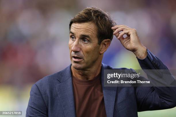 Channel 9 commentator and former player Andrew Johnslooks on before the round one NRL match between Newcastle Knights and Canberra Raiders at...