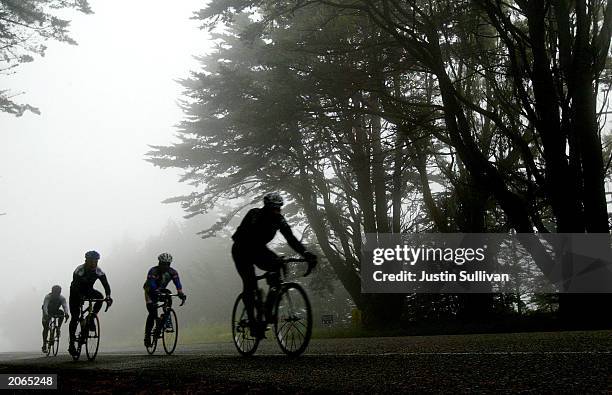 Cyclists ride dense fog on the first day of the second annual AIDS/LifeCycle event June 8, 2003 in San Bruno, California. More than 1,500 cyclists...