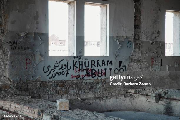 General view inside a silo, a crumbling building lacking sanitation, drinking water and a roof, where migrants sleep inside tents, some made with...