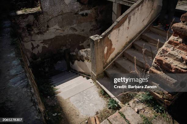 General view inside a silo, a crumbling building lacking sanitation, drinking water and a roof, where migrants sleep inside tents, some made with...