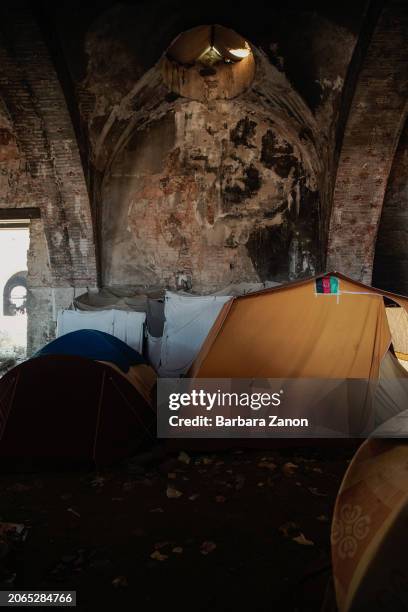 General view inside a silo, a crumbling building lacking sanitation, drinking water and a roof, where migrants sleep inside tents, some made with...