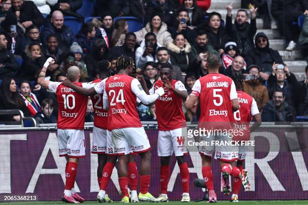 Reims' Ivorian forward Oumar Diakite is congratulated by teammates after scoring his team's second goal during the French L1 football match between...