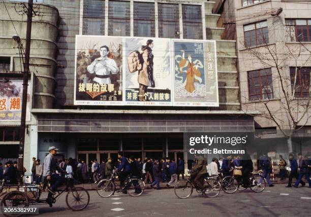 View of cyclists and pedestrians outside a cinema in Shanghai, China, January 25th 1979.