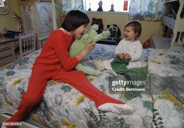 American gymnast Tracee Talavera, aged 12, playing with her coach's 18-month-old daughter, Donijo Mulvihill, at the Mulvihills' home in Eugene,...