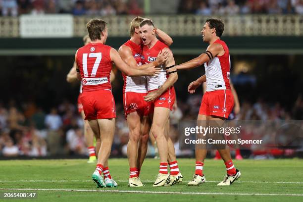 Chad Warner of the Swans celebrates kicking a goal with team mates during the Opening Round AFL match between Sydney Swans and Melbourne Demons at...