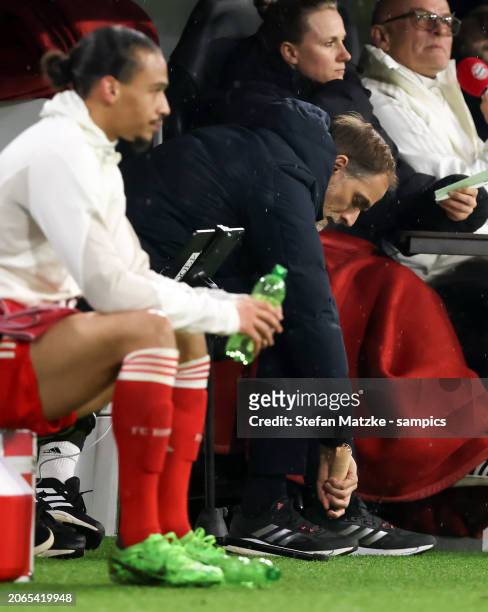 Thomas Tuchel of FC Bayern Muenchen ices his toe through his shoe with an icing spray Tuchel had damaged his toe during his emotional pre-match...