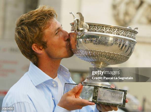 Juan Carlos Ferrero of Spain kisses the trophy after winning his mens final match against Martin Verkerk of the Netherlands during the 14th day of...