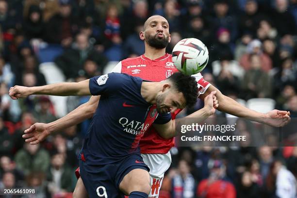 Paris Saint-Germain's Portuguese forward Goncalo Ramos fights for the ball with Reims' Moroccan French defender Yunis Abdelhamid during the French L1...