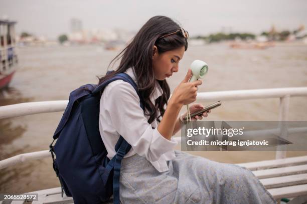 tourist on a boat ride in bangkok - hand fan stock pictures, royalty-free photos & images