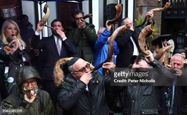 Participants blow their Shofar horns as they take part in The Blow For Hostages event at St John's Synagogue, on March 10, 2024 in London, England....
