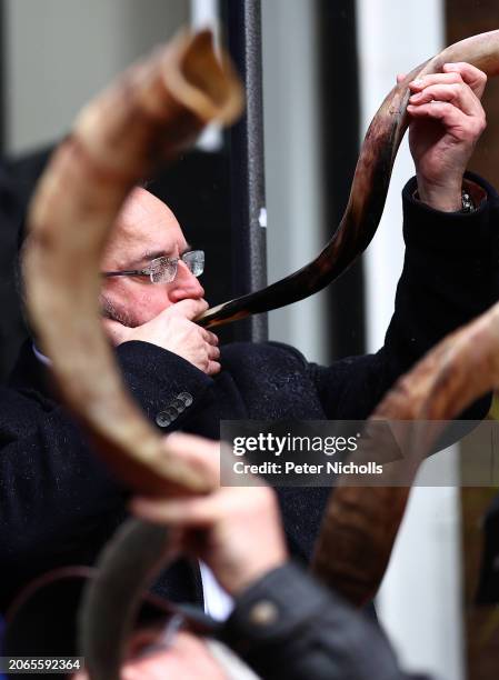 Participant blows a Shofar horn during The Blow For Hostages event at St John's Synagogue, on March 10, 2024 in London, England. With the war on Gaza...