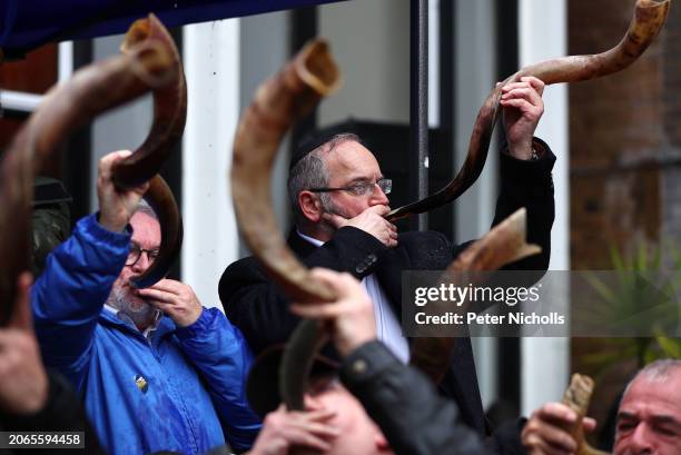 Participants blow their Shofar horns as they take part in The Blow For Hostages event at St John's Synagogue, on March 10, 2024 in London, England....