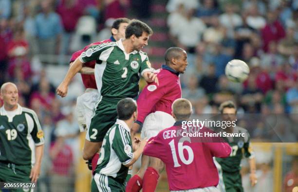 German footballer Markus Babbel rises above British footballer Paul Ince, German footballer Marco Bode, and British footballer Steven Gerrard during...