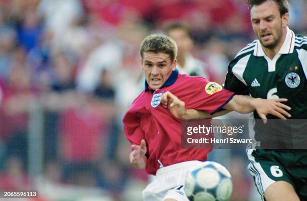 British footballer Michael Owen under pressure from German footballer Jens Nowotny during the UEFA Euro 2000 Group A match between England and...