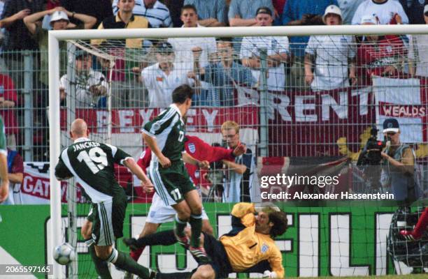 German footballer Carsten Jancker and his international teammate, German footballer Christian Ziege putting pressure on British footballer David...