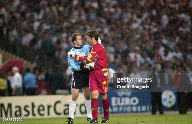 German footballer Andreas Kopke embraces British footballer David Seaman during the UEFA Euro 1996 semifinal match between England and Germany, held...