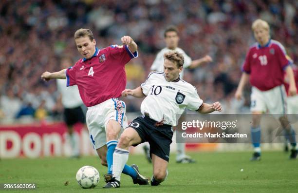 Czech footballer Pavel Nedved tackled by German footballer Thomas Hassler during the UEFA Euro 1996 final between the Czech Republic and Germany,...