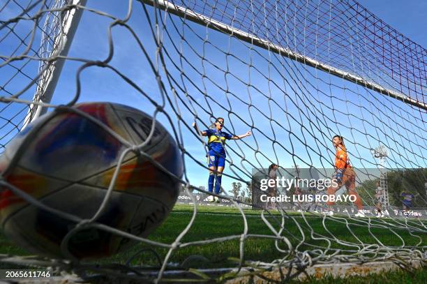 Boca Junior's midfielder Clarisa Huber celebrates a goal by teammate midfielder Camila Gomez as River Plate's goalkeeper Martina Krotter looks on...