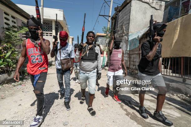 Gang Leader Jimmy 'Barbecue' Cherizier patrolling the streets with G-9 federation gang members in the Delmas 3 area on February 22 in Port-au-Prince,...