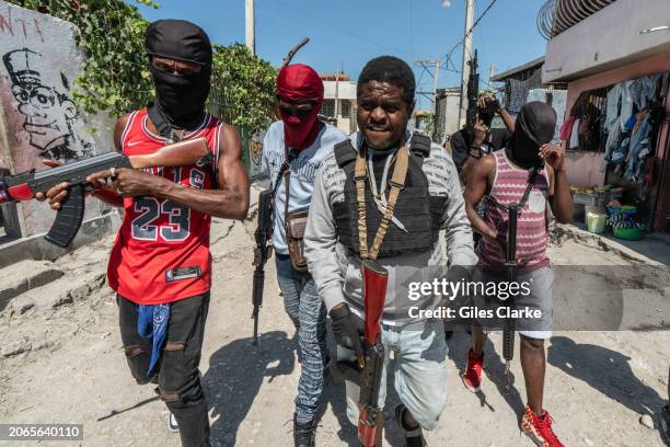 Gang Leader Jimmy 'Barbecue' Cherizier patrolling the streets with G-9 federation gang members in the Delmas 3 area on February 22 in Port-au-Prince,...