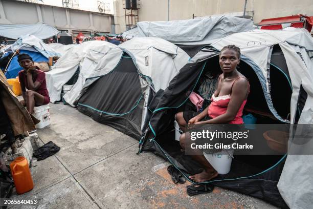 Woman by her tent at the St Vincent school turned displacement site in downtown Port au Prince on February 20 in Port-au-Prince, Haiti. The site is...
