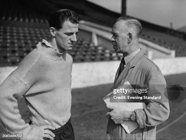 English footballer Jimmy Meadows , of Manchester City FC, speaking with trainer Laurie Barnett at Maine Road Stadium, May 1st 1955.