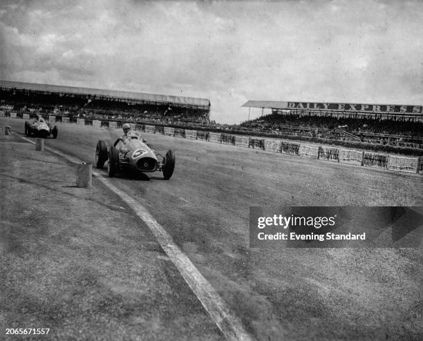 Italian racing driver Alberto Ascari in a Ferrari 500 , competing in the British Grand Prix at Silverstone Circuit, Northamptonshire, July 18th 1953....