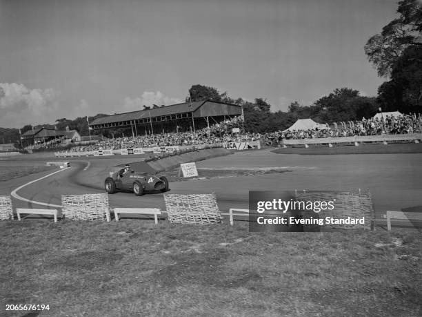 British racing driver Mike Hawthorn competing in the Woodcote Cup at Goodwood Circuit in Sussex, September 26th 1953. He is driving a Ferrari 125...