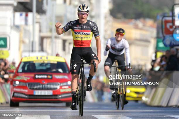 Soudal QuickStep's Belgian cyclist Remco Evenepoel celebrates as he crosses the finish line ahead of Team Visma-Lease a Bike's US cyclist Matteo...