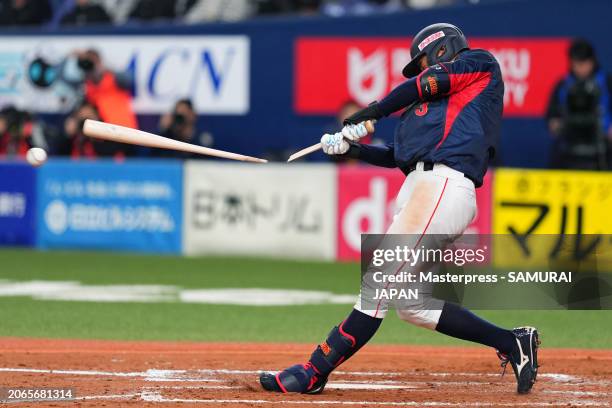 Outfielder Misho Nishikawa of Samurai Japan hits a grounder while breaking his bat in the 9th inning against Team Europe at Kyocera Dome Osaka on...