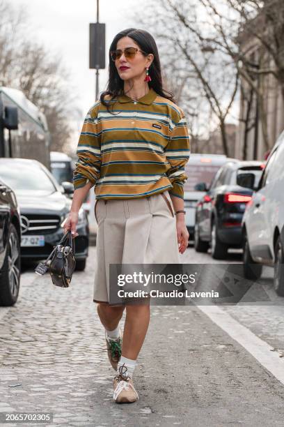 Mehrnaz Ansari wears olive green and blue striped polo neck Miu Miu top, beige Miu Miu shorts with brown details, brown Miu Miu bag, beige Miu Miu...