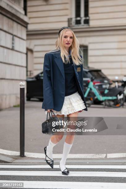 Leonie Hanne wears blue checked shirt, blue jumper, white ruffle mini skirt, blue Miu Miu blazer, white Miu Miu socks, black Miu Miu kitten heels,...