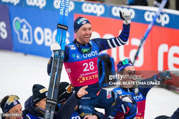 France's Maurice Manificat is celebrated by team mates after finishing the Men's Mass Start 50 km Classic race during the FIS Cross Country World Cup...