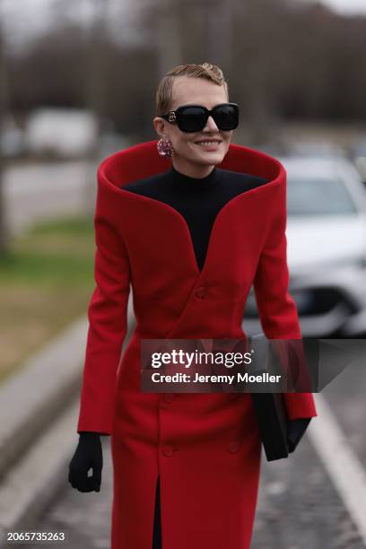 Renata Litvinova is seen wearing Balenciaga Outfit including black tights, black shades, black hand gloves, rose diamond earrings, a black top with...