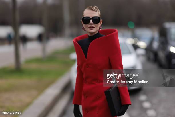 Renata Litvinova is seen wearing Balenciaga Outfit including black tights, black shades, black hand gloves, rose diamond earrings, a black top with...
