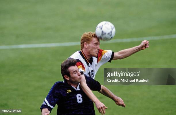 British footballer Brian McClair and German footballer Matthias Sammer leap for the ball during the UEFA Euro 1992 Group 2 match between Scotland and...